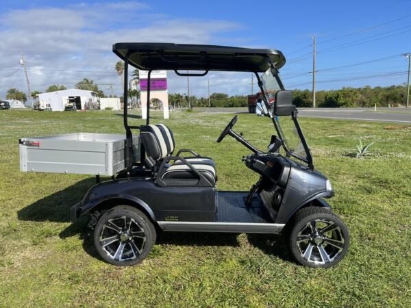 Side profile of 2025 Evolution Turfman 200 black utility vehicle available in Virginia with nationwide delivery and export