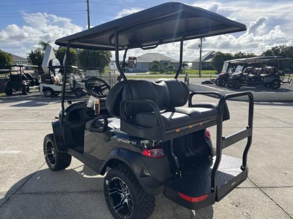 Side view of 2026 Club Car Onward Lifted 4 Passenger Gas golf cart with rugged tires