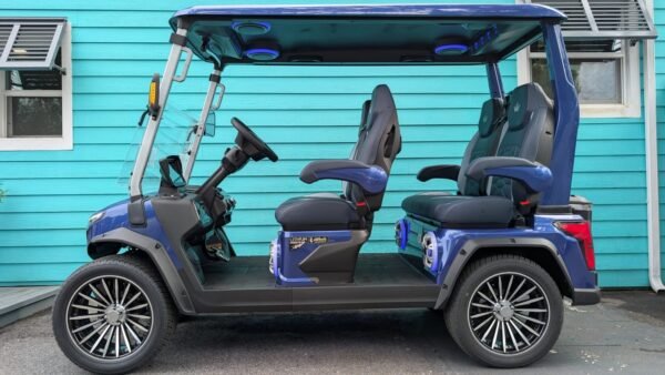 Side view of the blue Evolution D-Max GT4 with four forward-facing seats