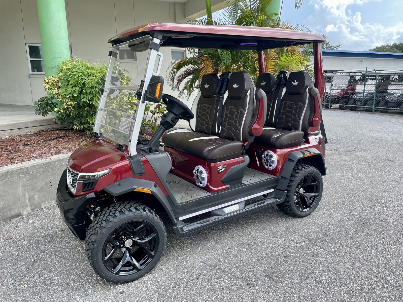 2026 Evolution D-MAX XT4 golf cart in red, front three-quarter view
