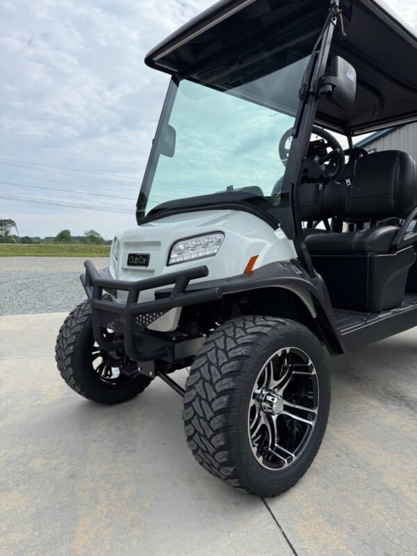 Front of the white Club Car Onward 4 Forward with brush guard