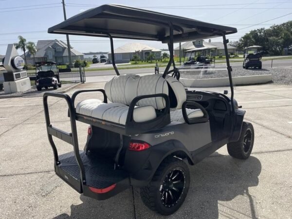 Rear three-quarter view of the black Club Car Onward Lifted 4 Passenger Gas