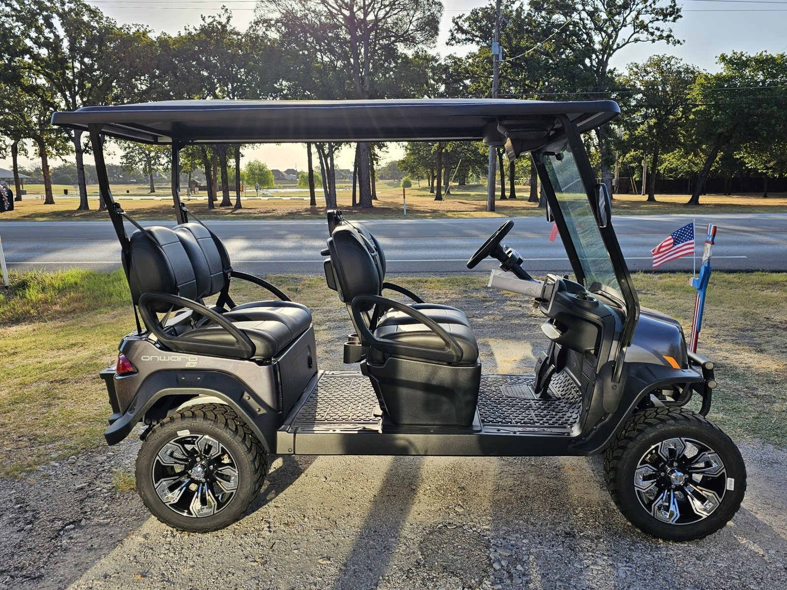 Side view of the black Club Car Onward 4 Forward showing four forward-facing seats