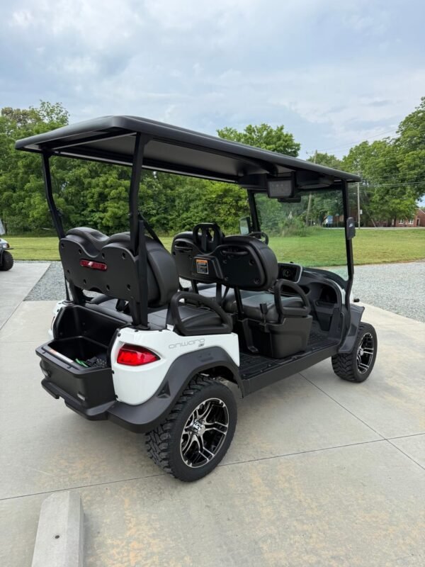 Rear three-quarter view of the white Club Car Onward 4 Forward